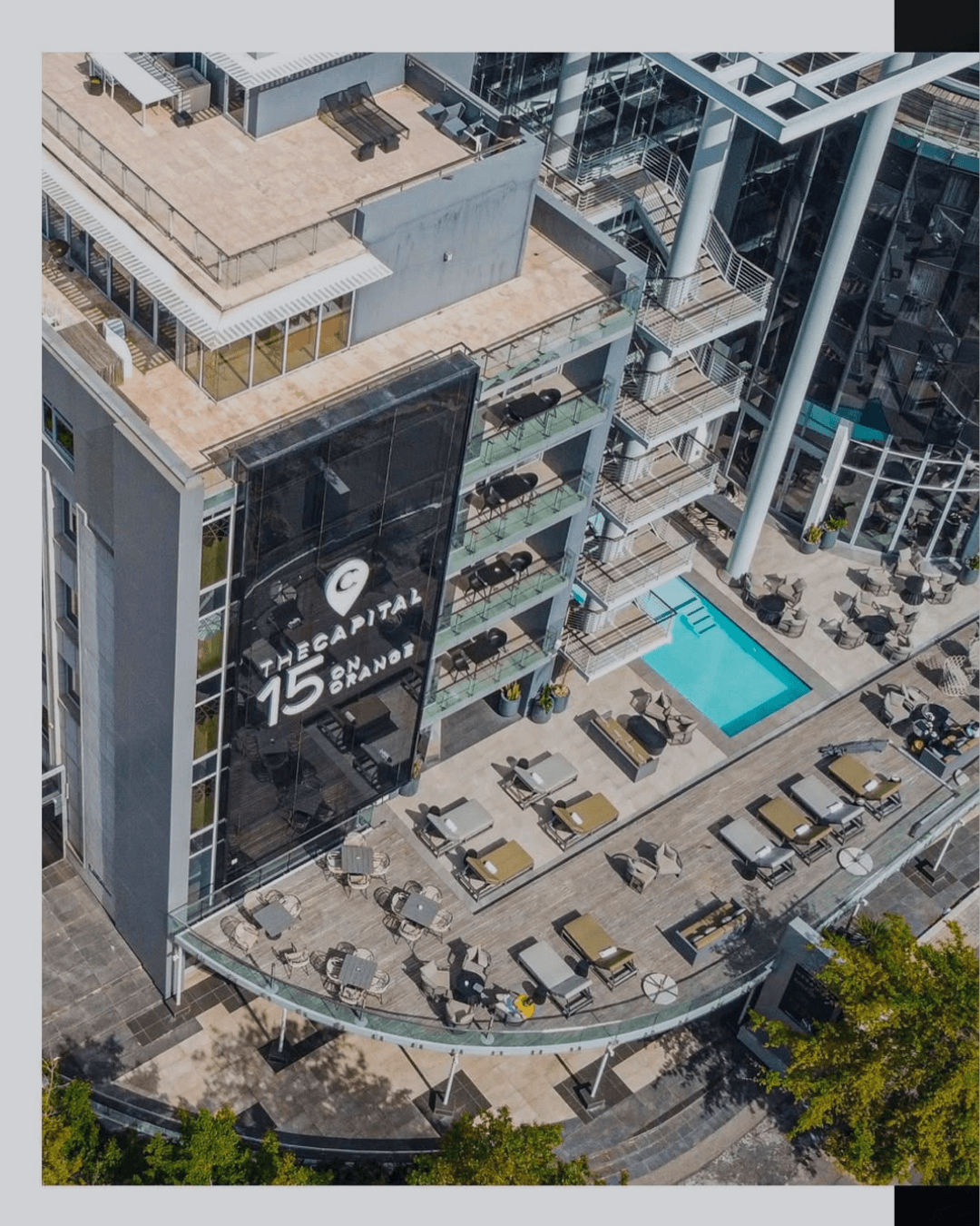 Aerial view of The Capital 15 on Orange hotel's rooftop terrace and pool area.